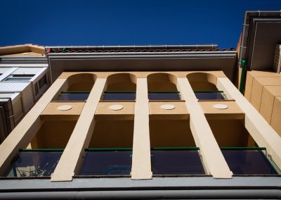 Rehabilitación de pintura en fachada, aleros, pasamanos de balcón y bajantes.